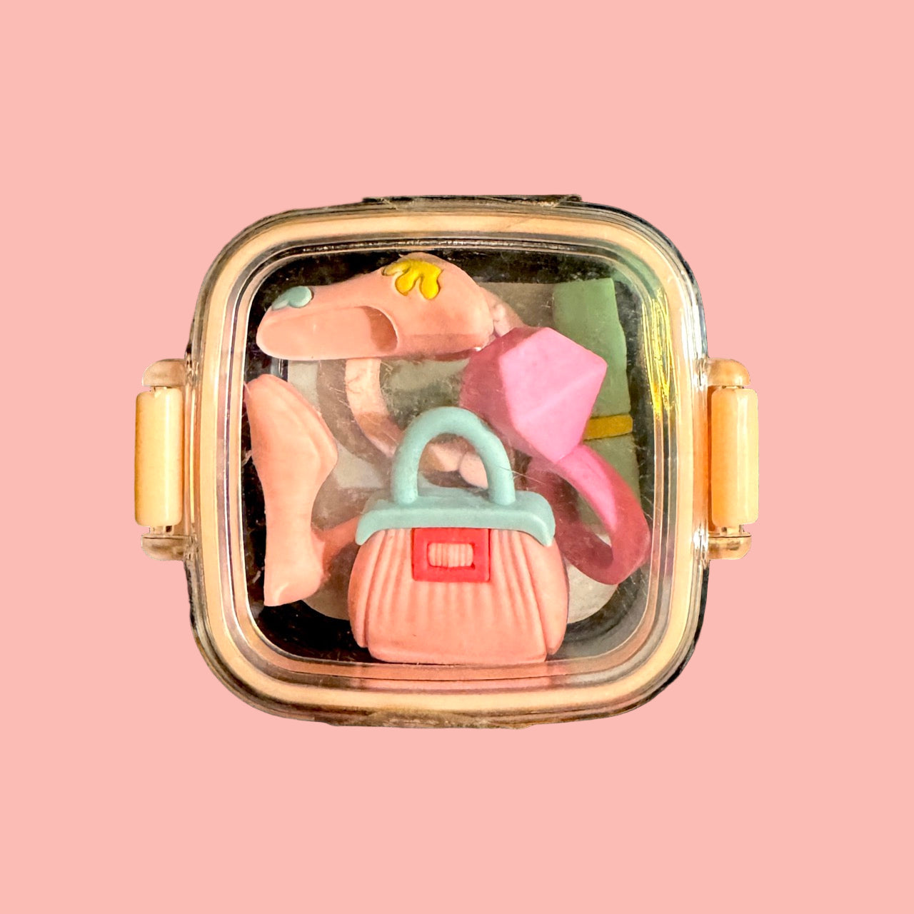 Decorative case with erasers on a peach background