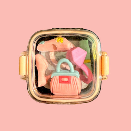 Decorative case with erasers on a peach background