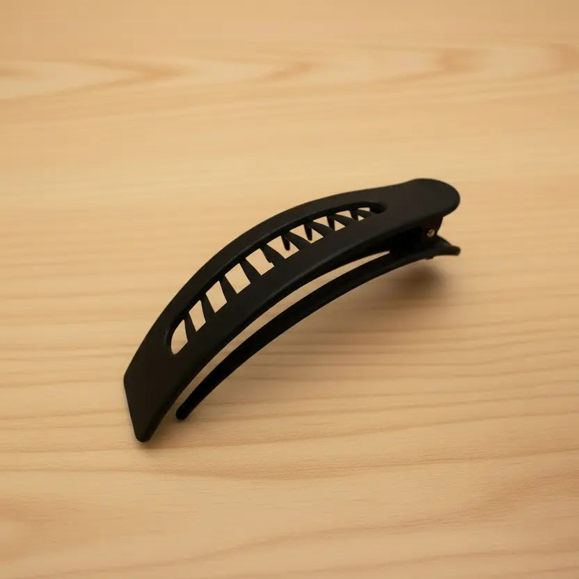 Black hair clip on a wooden surface