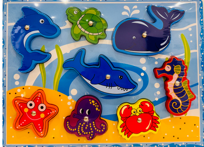 Set of colorful sea-themed wooden puzzles in a box