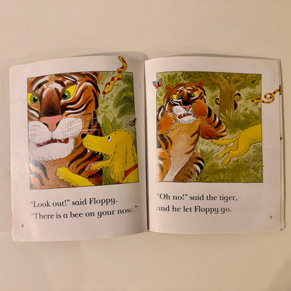 Open book with illustrations of a tiger and a dog in a jungle setting