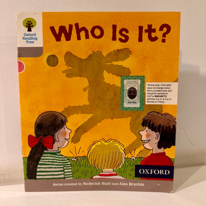 Book cover of 'Who Is It?' by Oxford with two children and a dog's shadow illustration on a orange background.