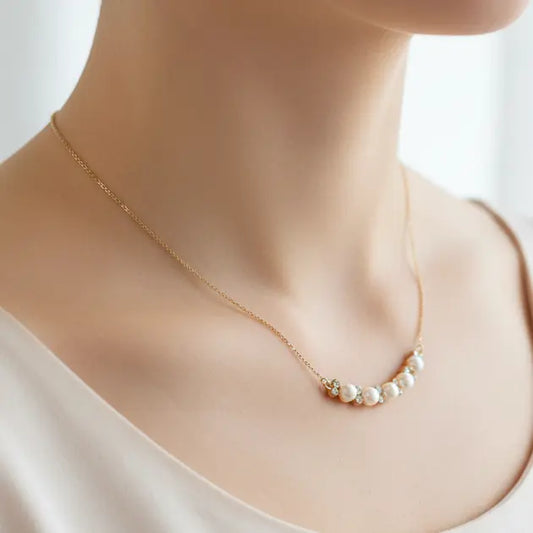 Pearl necklace on a mannequin with a plain background