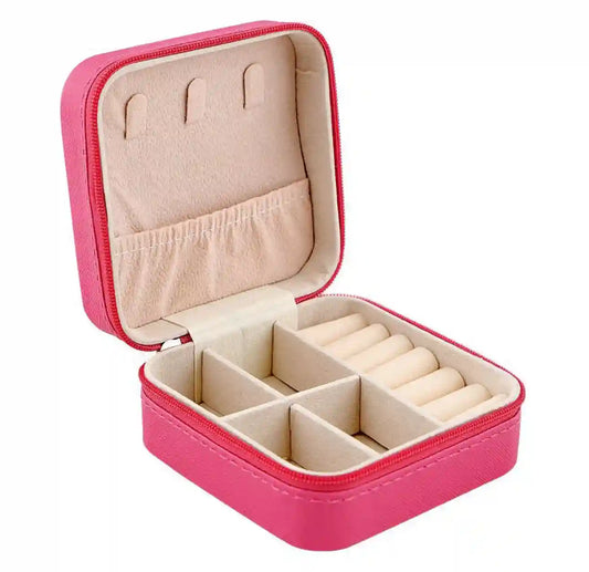 Pink jewelry case with beige interior on a white background