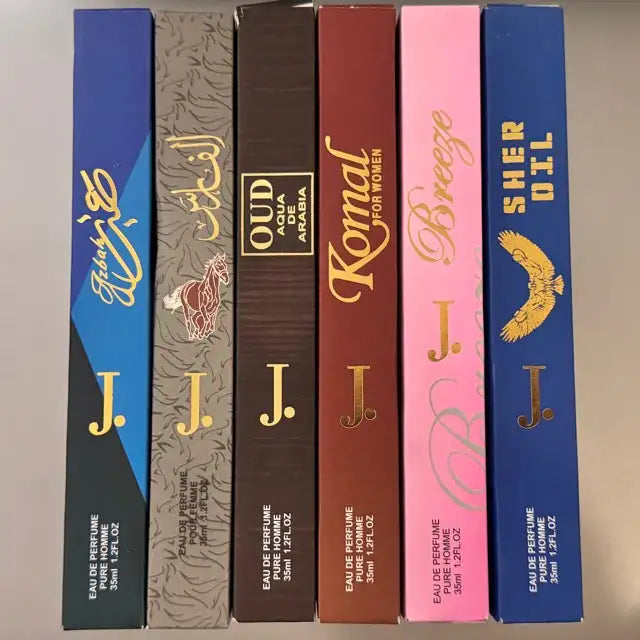 Collection of perfume boxes with various designs and colors on a neutral background