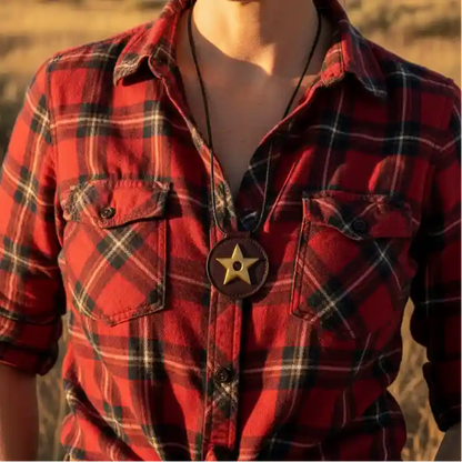 Red plaid shirt with a star necklace on a blurred natural background