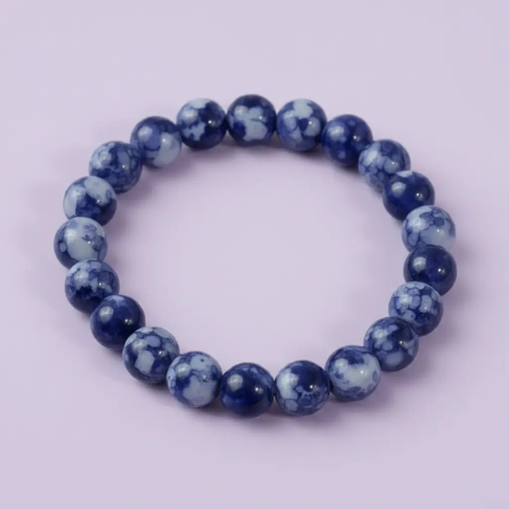 Blue beaded bracelet on a light purple background