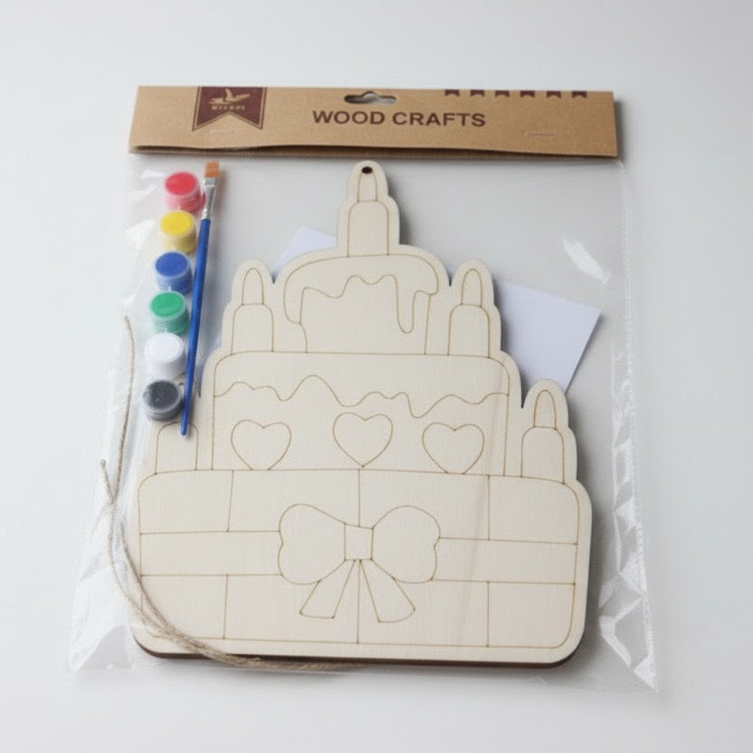 Wooden craft kit with castle design, paintbrushes, and markers on a white background